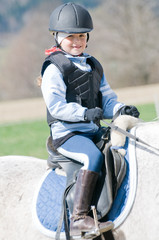 Obraz premium Horse riding - little girl is riding a horse