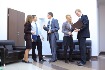 Successful business man standing with his staff in