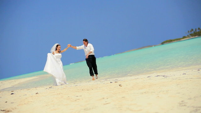 Happy Wedding Couple Dancing in the Ocean