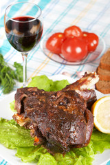 Roast leg of lamb on decorated table