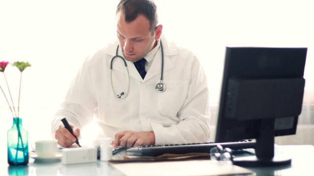 Male doctor showing HEALTH word on sheet of paper