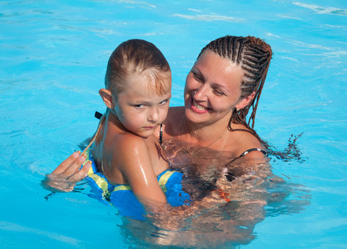 Mother and son have fun swimming