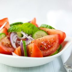 Tomato and cucumber salad with black pepper and basil