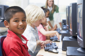 Kindergarten children learning how to use computers.