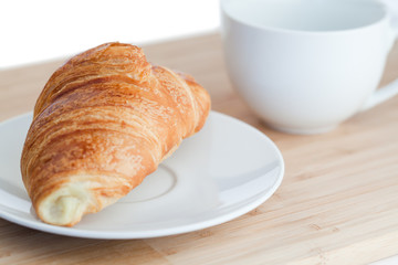Breakfast with coffee and croissants