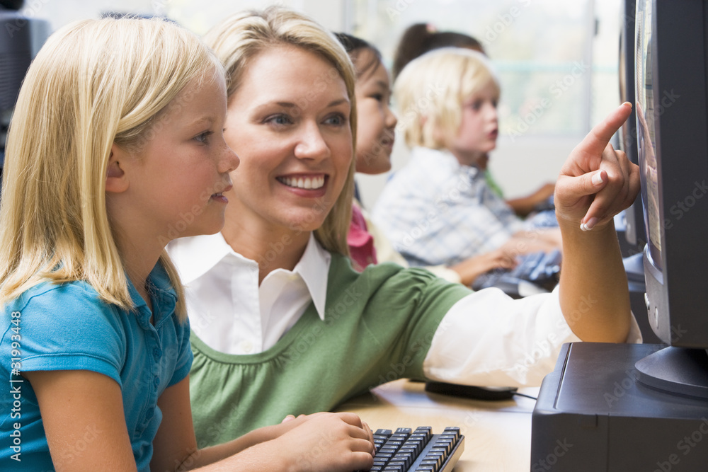 Sticker teacher helping kindergarten children learn how to use computers