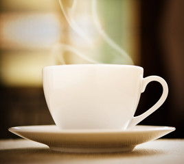 White hot cup of coffee on the table