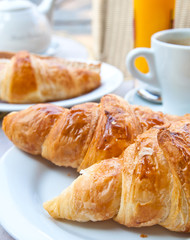 Breakfast with coffee and croissants