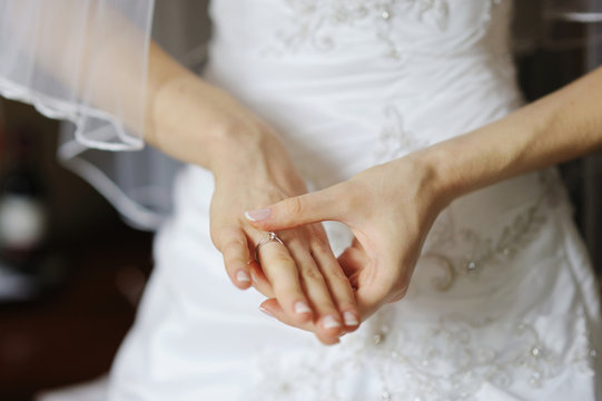 Bride adjusting her wedding or angagement ring