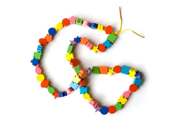 Handmade necklace from colourful beads on a white background