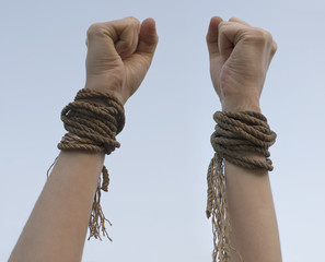 Tied hands with broken rope