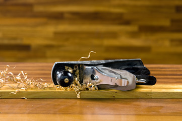 Wood planer on workbench with wood shavings.