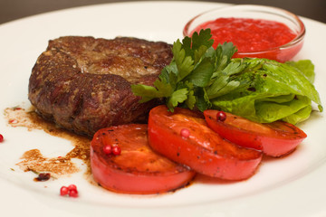 Grilled steak with garnish - closeup