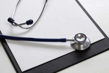 Black clipboard with  stethoscope. Medicine concept.