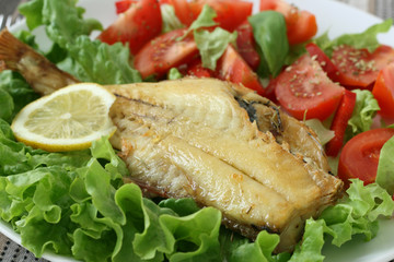 fried red-fish with salad and lemon