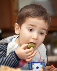 Little boy eats pickles