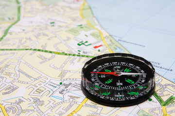 business travel concept. compass on city map background.