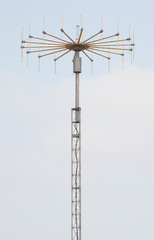Obraz premium antenna on mast on blue sky background
