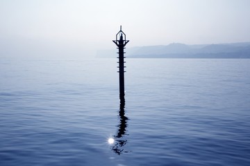 Obraz premium backlight beacon in Mediterranean blue sea reflection