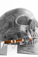 Skull with burning cigarette in mouth
