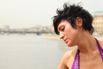 Portrait of girl with luxuriant hairs in purple clothes