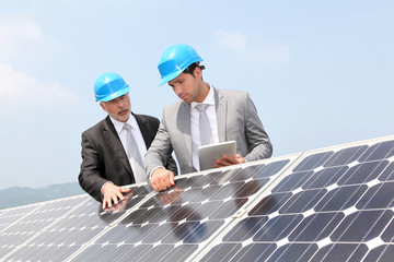 Engineers checking solar panels setup
