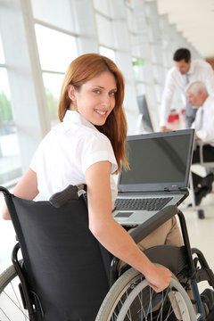 Businesswoman in wheelchair at work