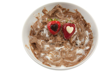 A plate of messy chocolate mousse with strawberries
