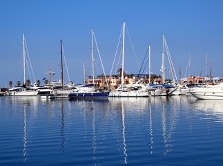Fototapeta na wymiar Boats in blue marina Mediterranean sea Denia