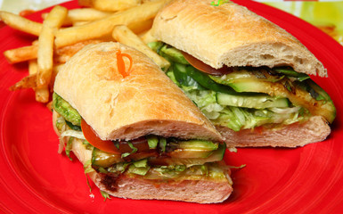 Vegetarian sandwiches on a red plate with fried potatoes