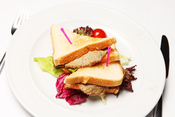 Sandwich with beef on a white plate