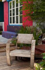 Fototapeta na wymiar Old wooden chair in modern garden