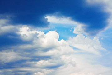 Dramatic blue sky with cumulus clouds