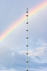 Tower antenna against rainbow