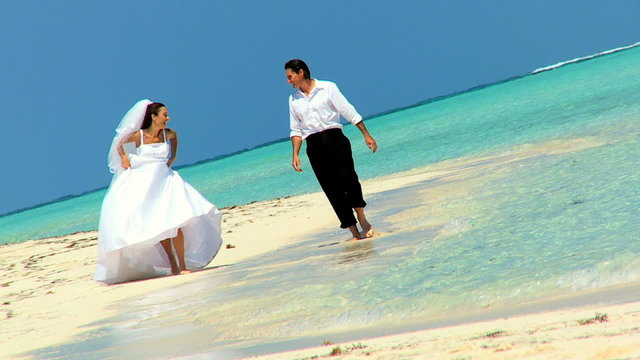 Caucasian Couple in Wedding Clothes on a Beach