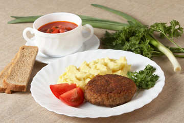Cutlet with mashed potatoes and soup