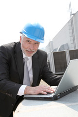 Businessman checking industrial site