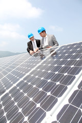 Engineers checking solar panels setup