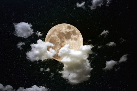 Full moon behind thick cloud