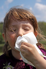 Allergies - the girl wipe your nose with a tissue - obrazy, fototapety, plakaty