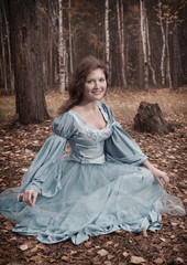 Fototapeta premium lgirl in medieval dress in autumn wood