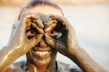An elderly woman enjoying the natural mineral mud on face