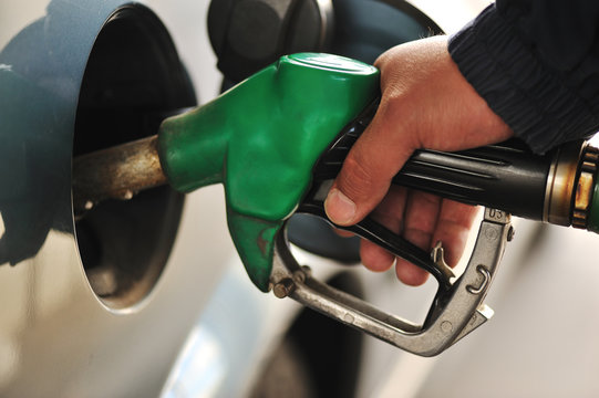 Man refilling the car with fuel on a filling station