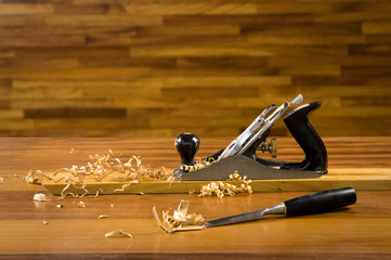 Wood planer on workbench with wood shavings.