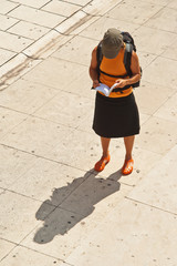 Female tourist looking into the tourist guide in Zadar, Croatia