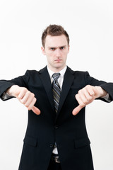 young businessman showing thumbs down