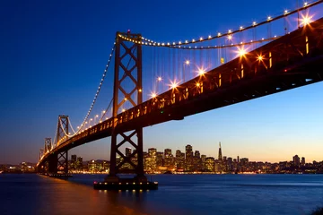 Rolgordijnen San Francisco skyline and Bay Bridge at sunset, California, USA © Oleksandr Dibrova