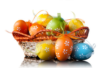 color easter eggs in basket isolated on white