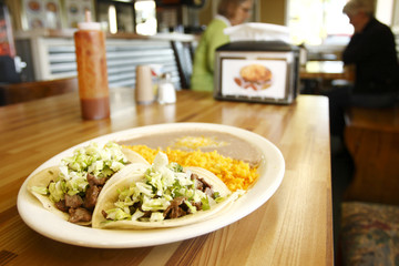 Steak tacos with rice and beans at a taqueria