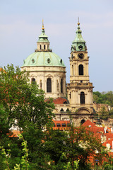 Fototapeta na wymiar Spring Prague St. Nicholas' Cathedral with the green Nature